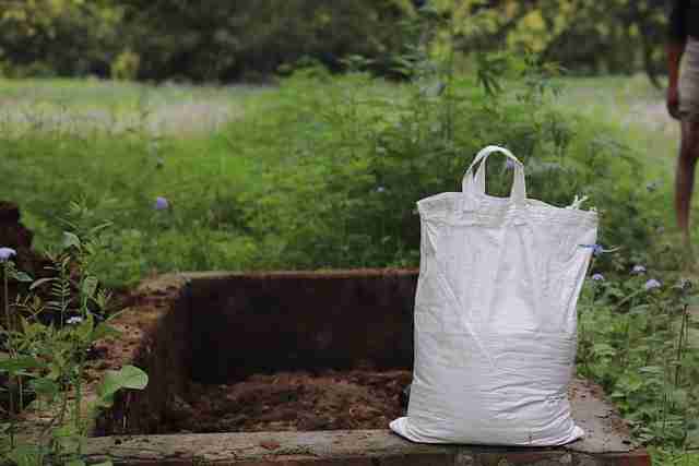 compost heap with a bag of compost filled to be taken away