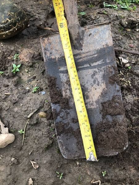 an image of a garden spade showing a tape measure along it