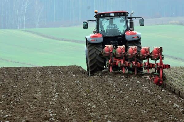 a tractor ploughing a field to sow a new crop